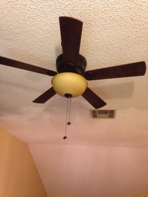 Electrician installing a light fixture