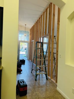 Carpenter measuring and cutting trim
